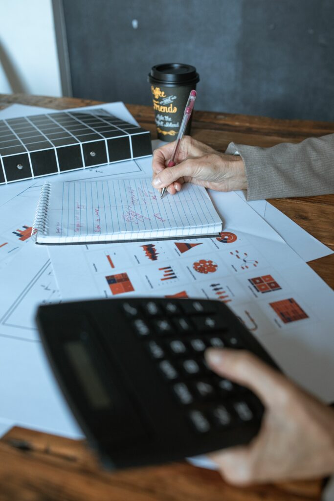 An office desk scene featuring charts, calculator, and coffee cup, ideal for business or finance themes.